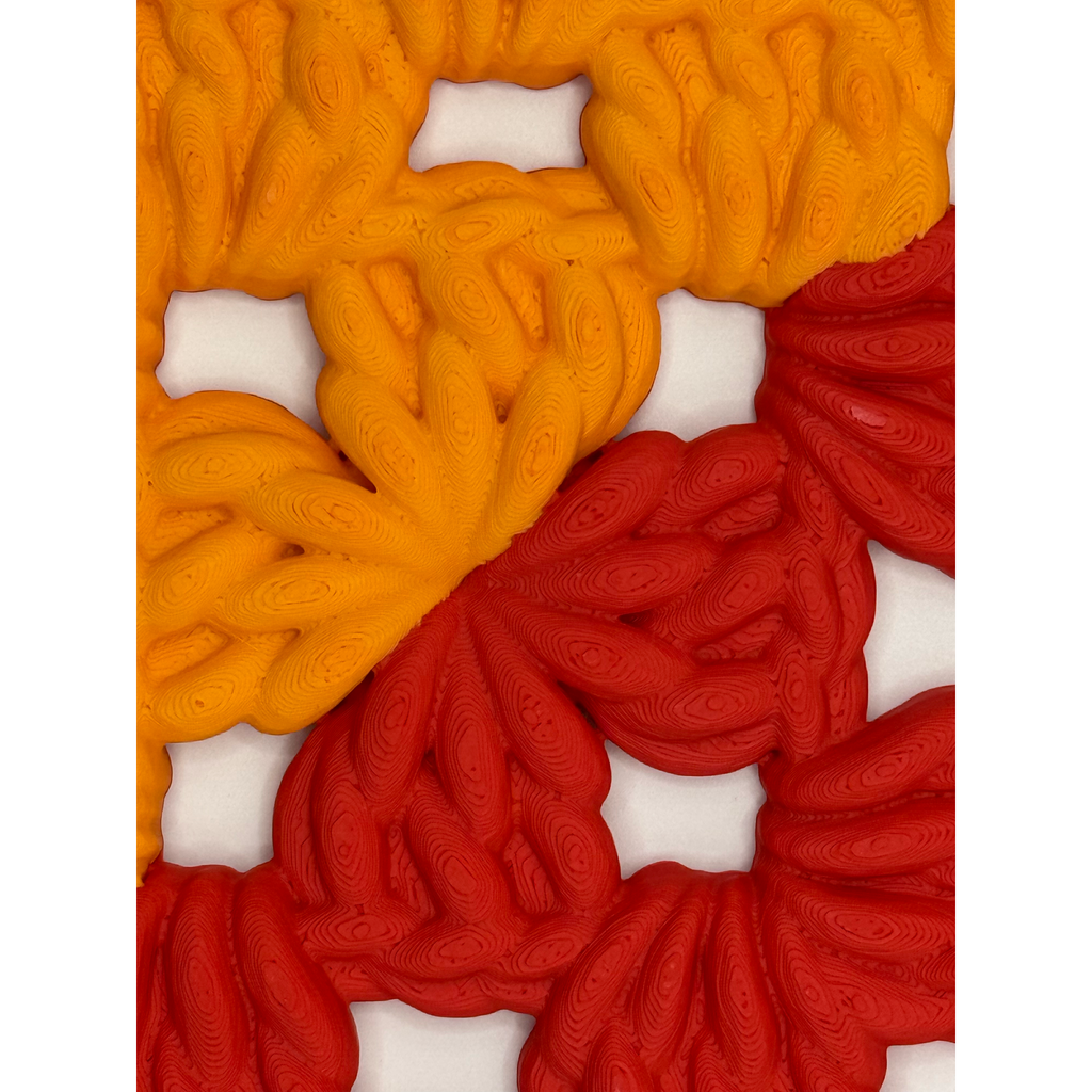 3D-printed wall art resembling a crocheted granny square